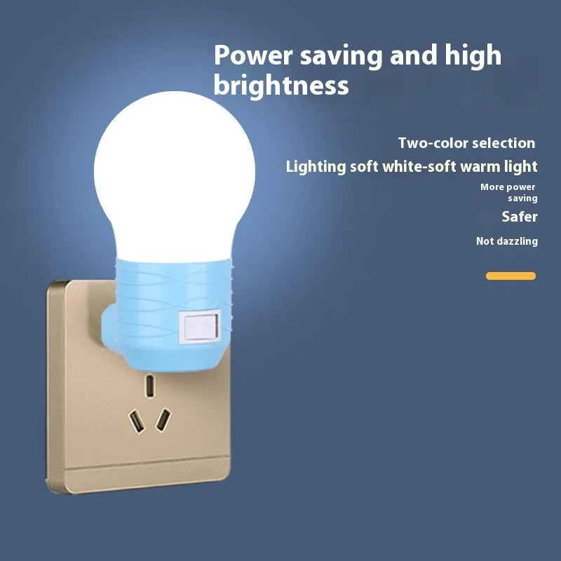 Plug-in baby night light in white shell on a nursery bedside table