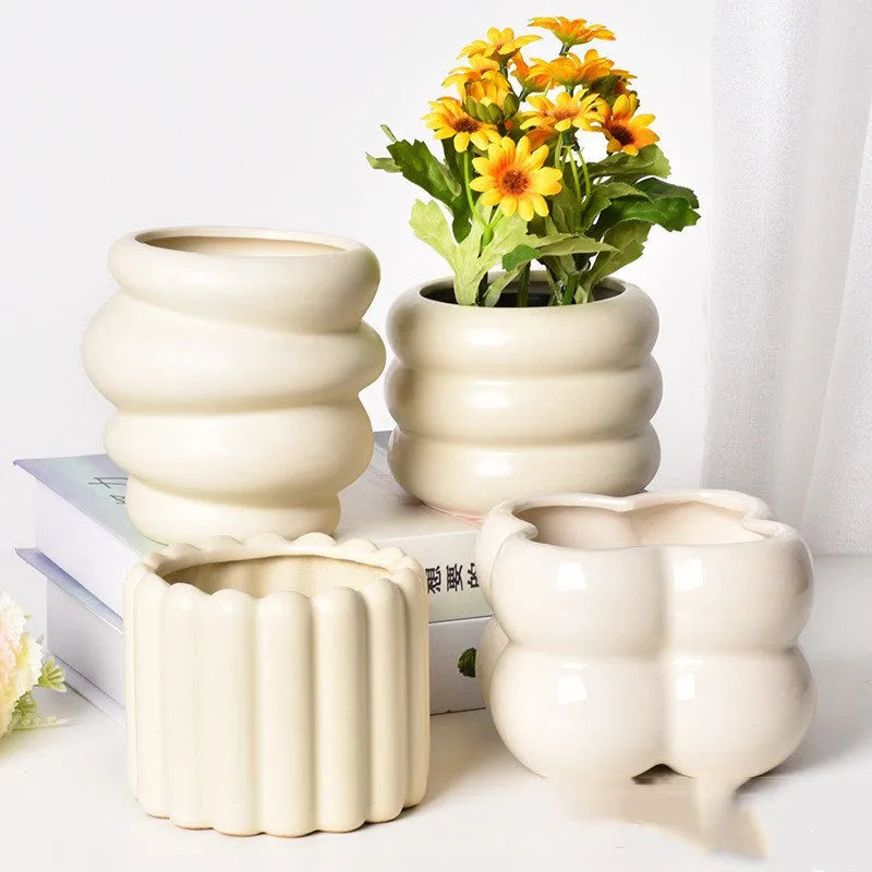 Roman column matte yellow ceramic flower pot on a surface.