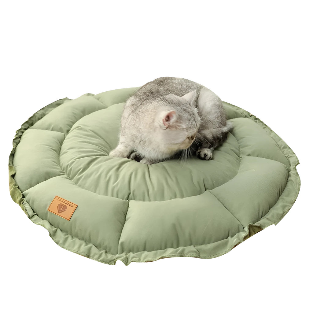 Grey reversible donut-shaped pet bed for cats and small dogs on a floor.