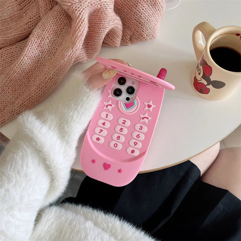 Light pink silicone flip phone case with built-in mirror for iPhone, showing cute cartoon design.