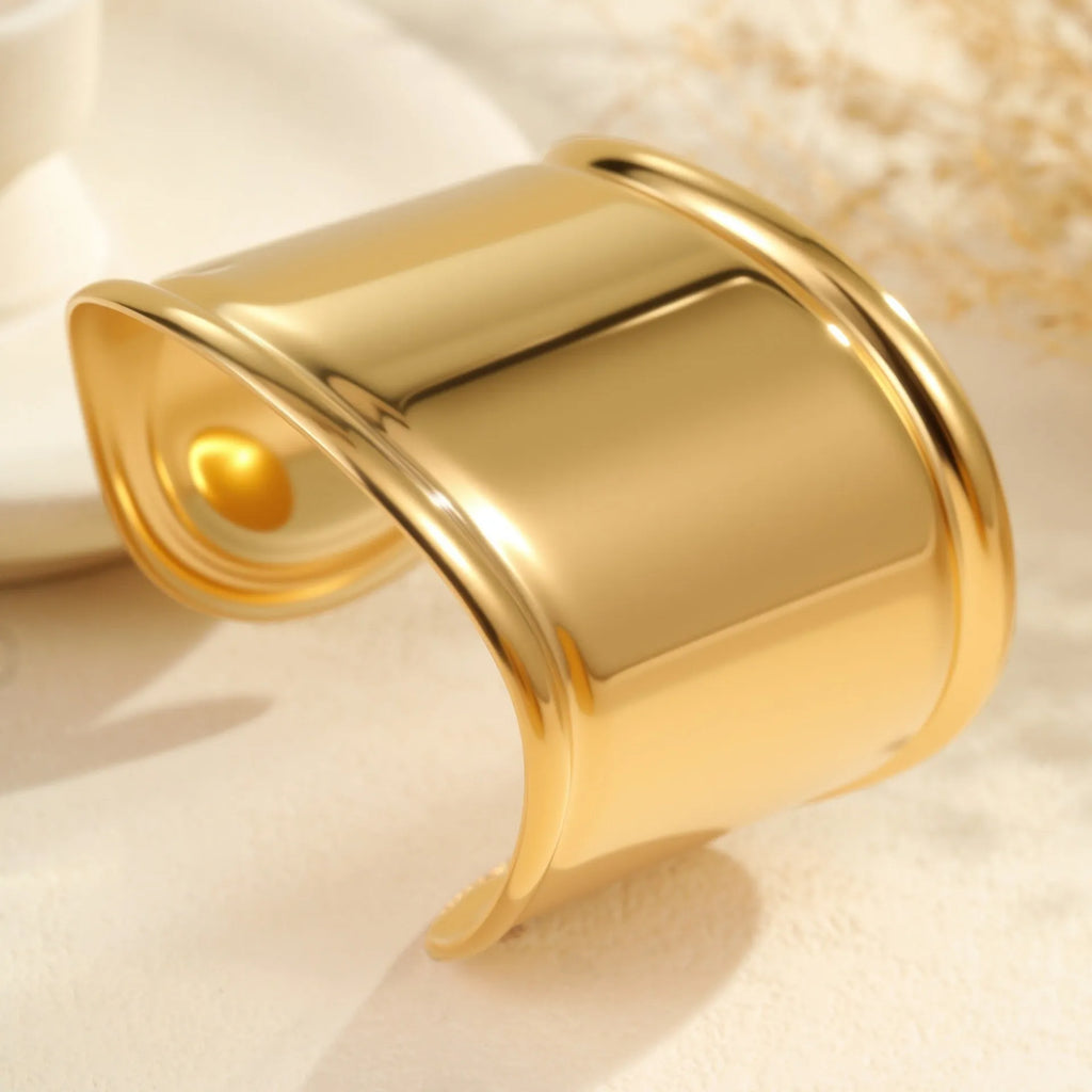 Gold plated stainless steel bracelet with exaggerated wide geometric wave design and asymmetric opening