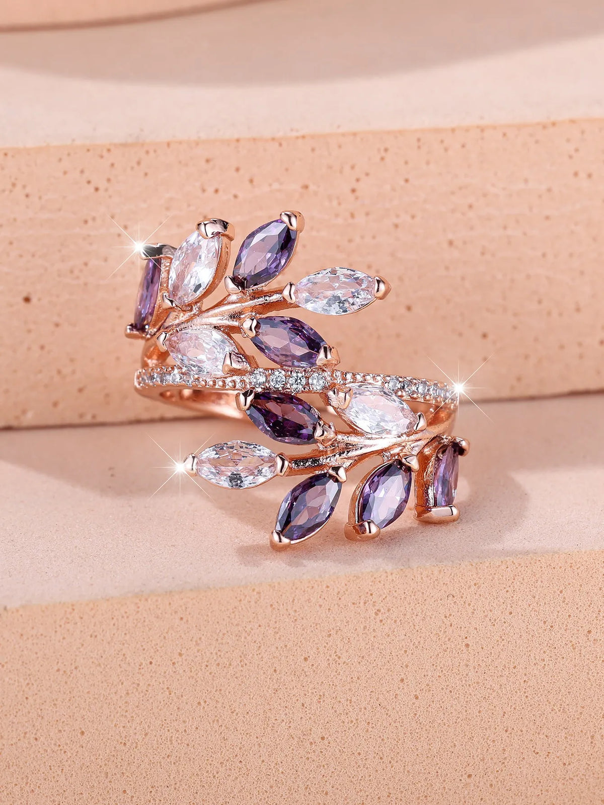 Adjustable horse eye zircon leaf ring in rose gold or platinum plating on a model's hand.