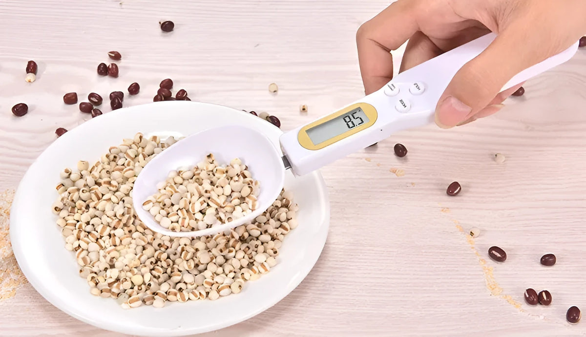 Black electronic measuring spoon scale showing digital display and integrated spoon design for kitchen weighing