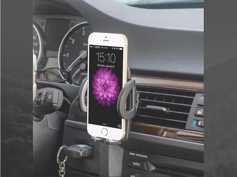 Black plastic mobile phone holder clipped to a car air conditioning vent.