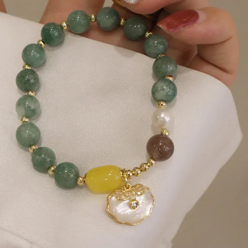 Adjustable green jade bead bracelet with a natural shell clasp fastening.