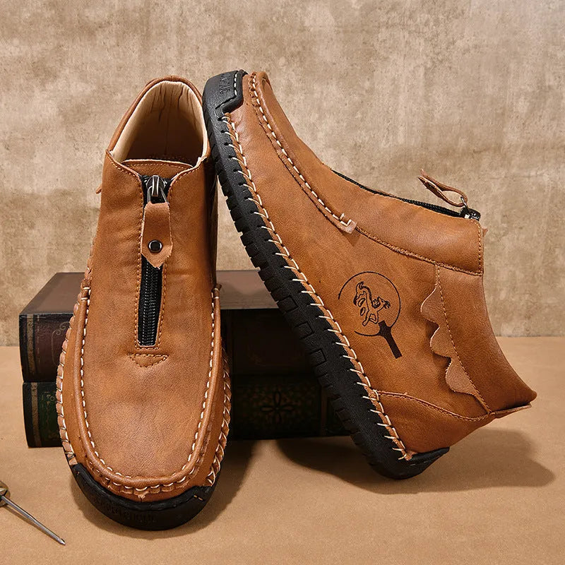 Men's black slip-on loafers with a round toe and rubber sole, shown in a casual style.