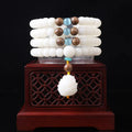 White jade bodhi bead long bracelet showing 6x8mm beads in a cloisonne style design.