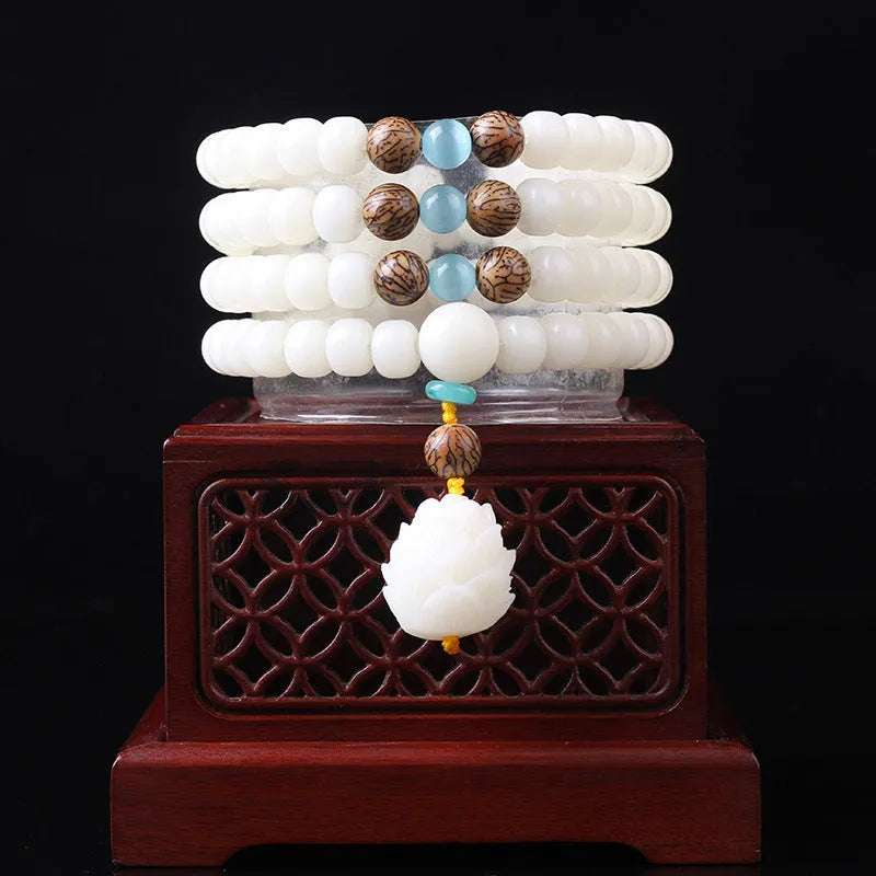 White jade bodhi bead long bracelet showing 6x8mm beads in a cloisonne style design.