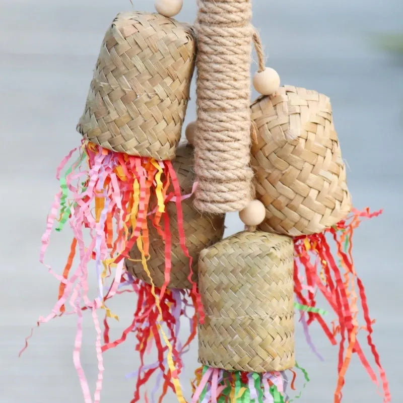 Parrot toy with wood and sisal construction containing colourful shredded paper, 15cm by 35cm