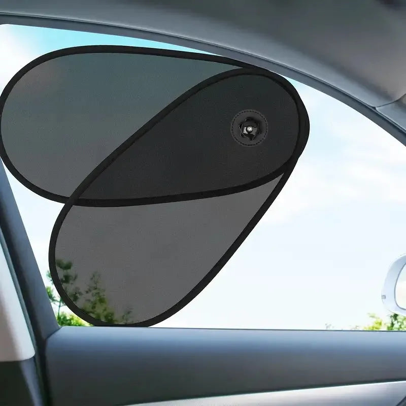 Black stretchy car side window sun shade with suction cups, installed on a car window.