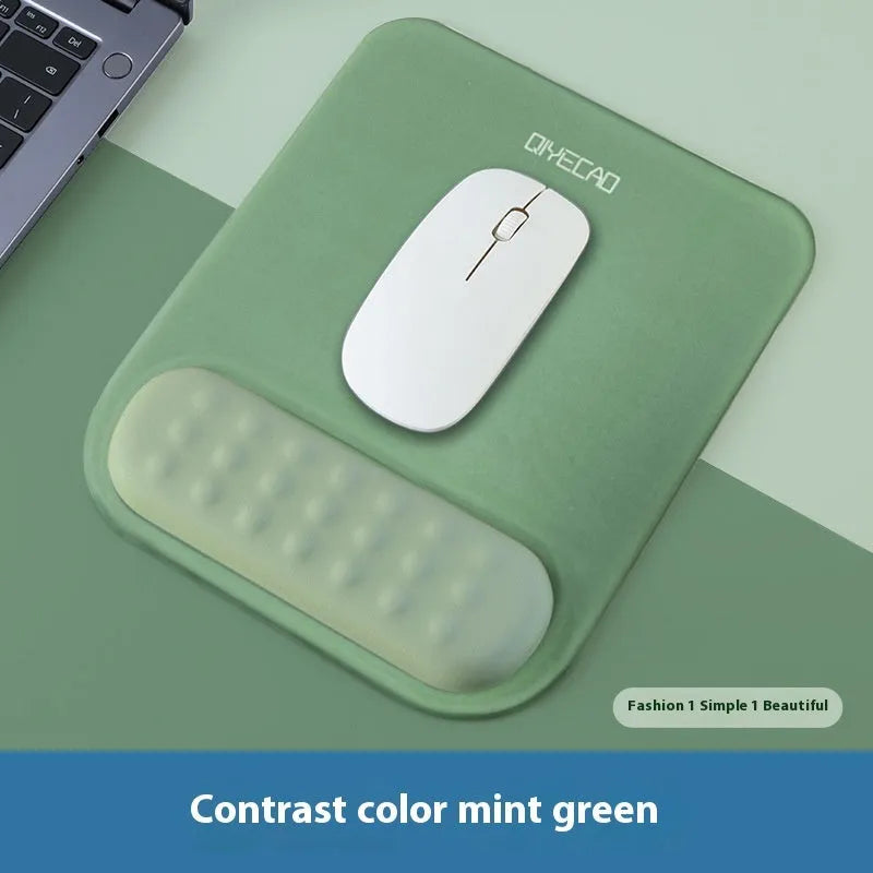 Ergonomic cloth-silicone mouse pad with raised wrist support on a desk