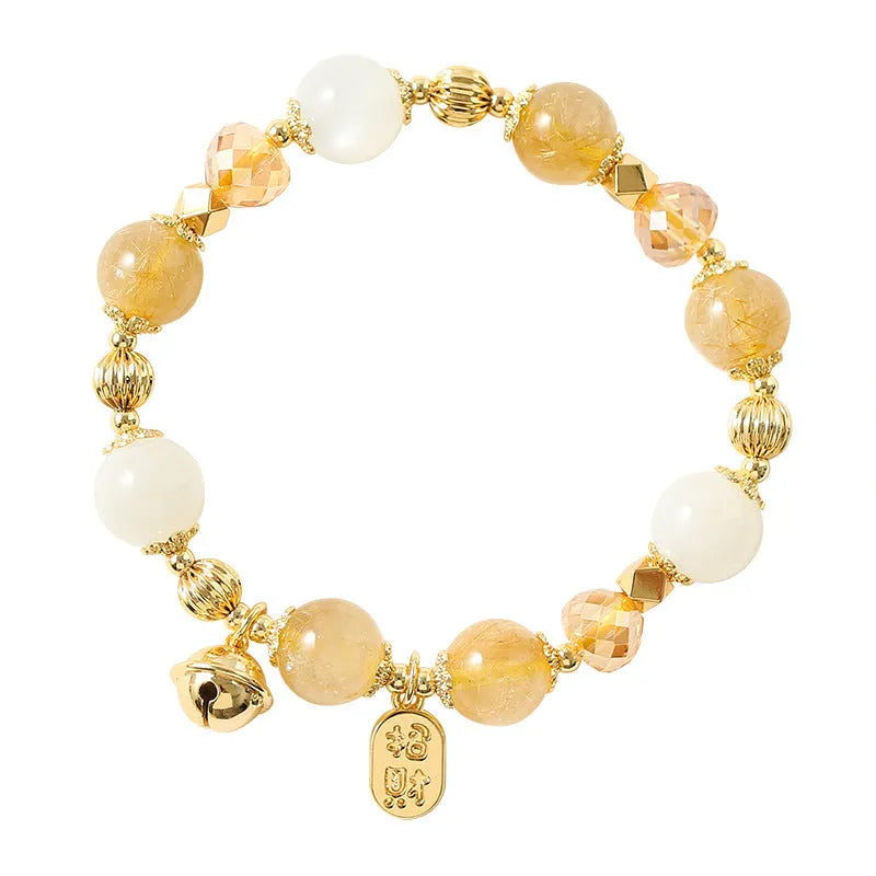 Gold electroplated adjustable bracelet with lucky fortune rutilated quartz crystal beads in a Korean style.