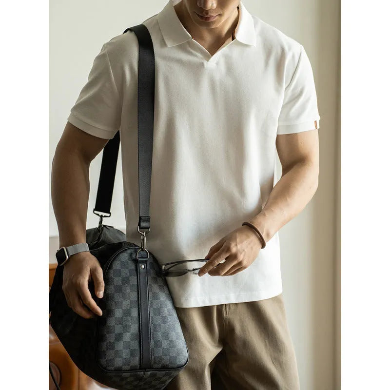 Man wearing a classic blue short-sleeved cotton blend polo shirt, showing regular fit and button placket.