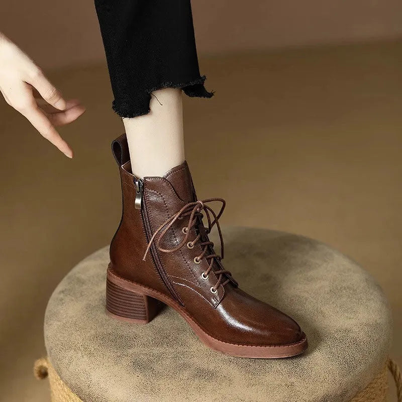Women's black pointed toe short tube boots with 5.5cm heel on wooden floor