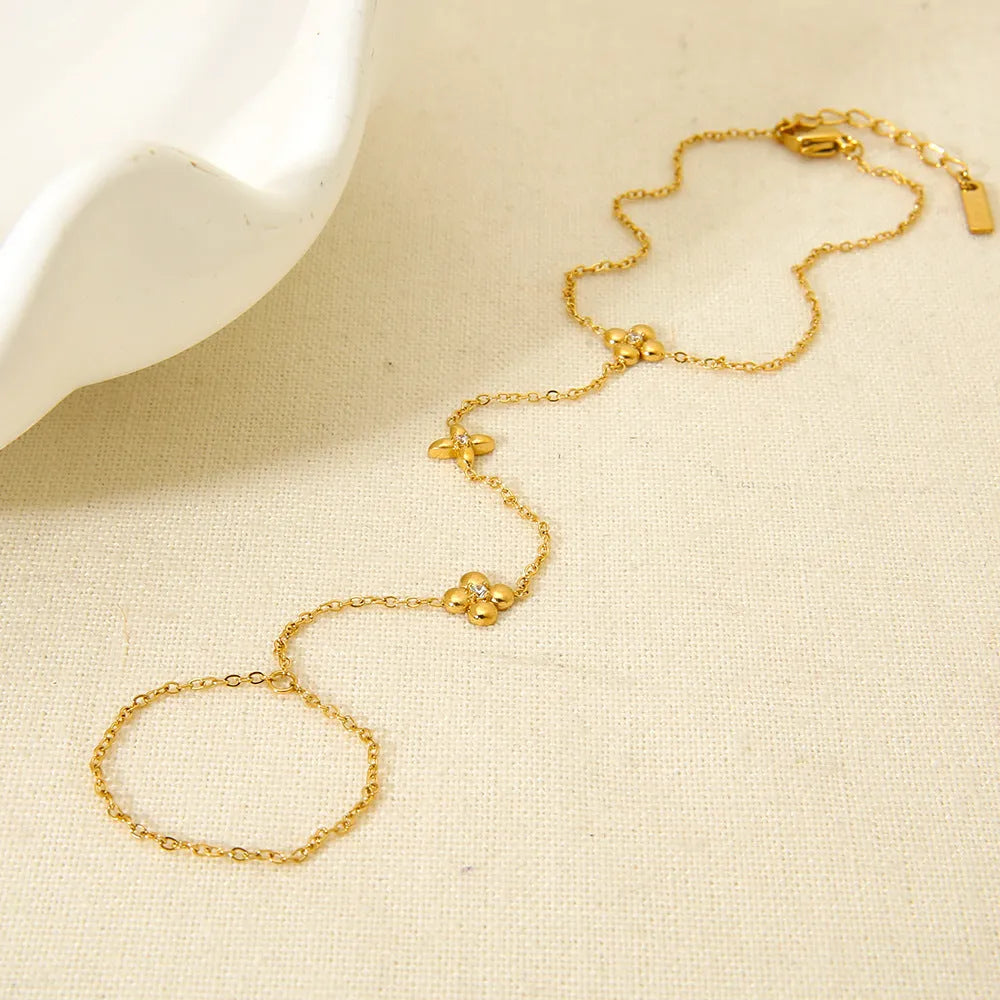 Gold-coloured women's bracelet with geometric flower and eight-pointed star design