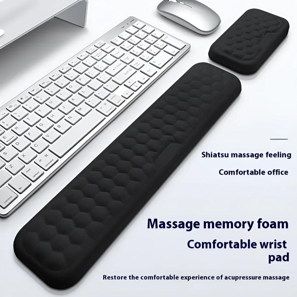 Black memory foam mouse wrist pad with a leather-style cover on a wooden desk