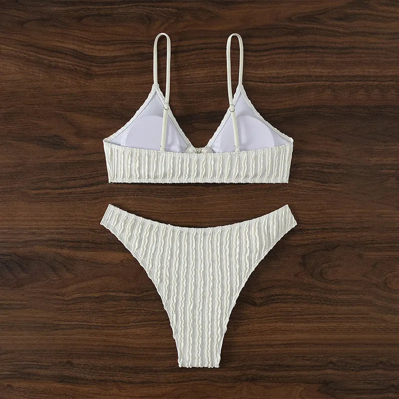 White women's V-neck swimsuit with split beach design, showing top and shorts.