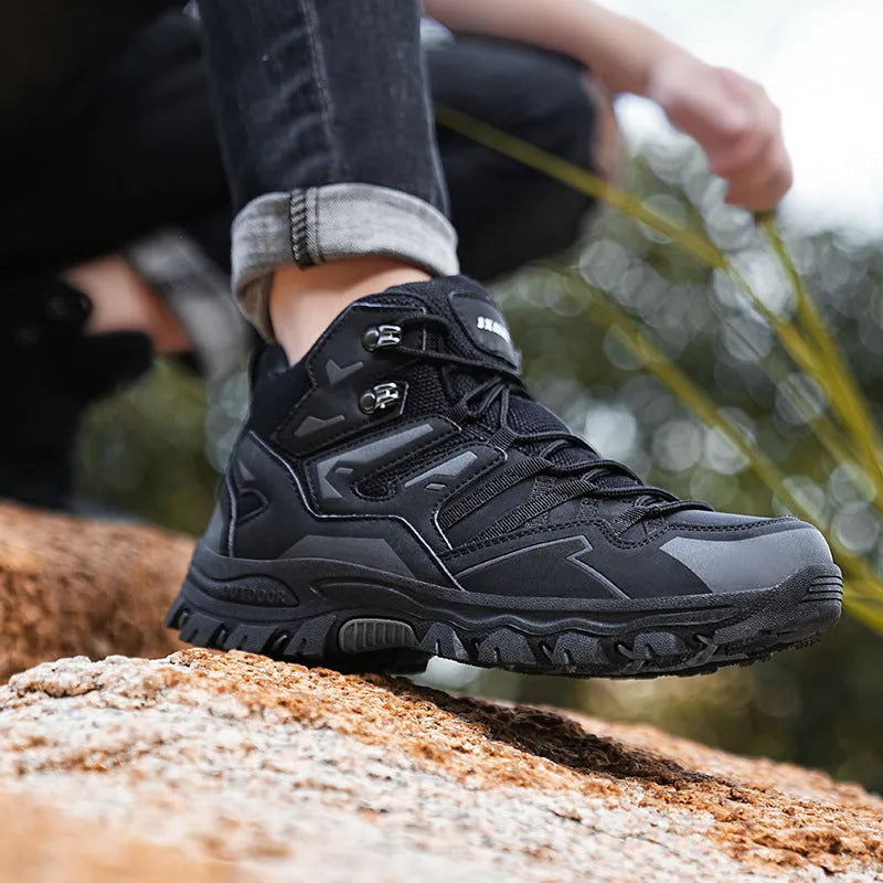 High-top hiking sneakers in multiple colours with flannel uppers and rubber soles on a rocky path.