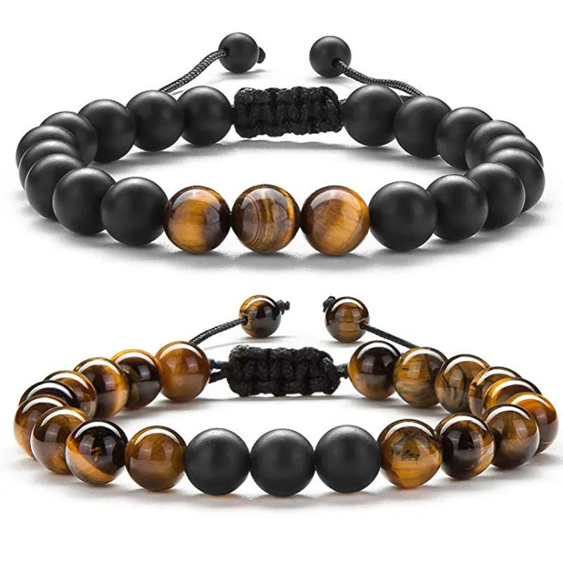 Matte black tiger eye agate couple bracelets with geometric beads on a neutral background.