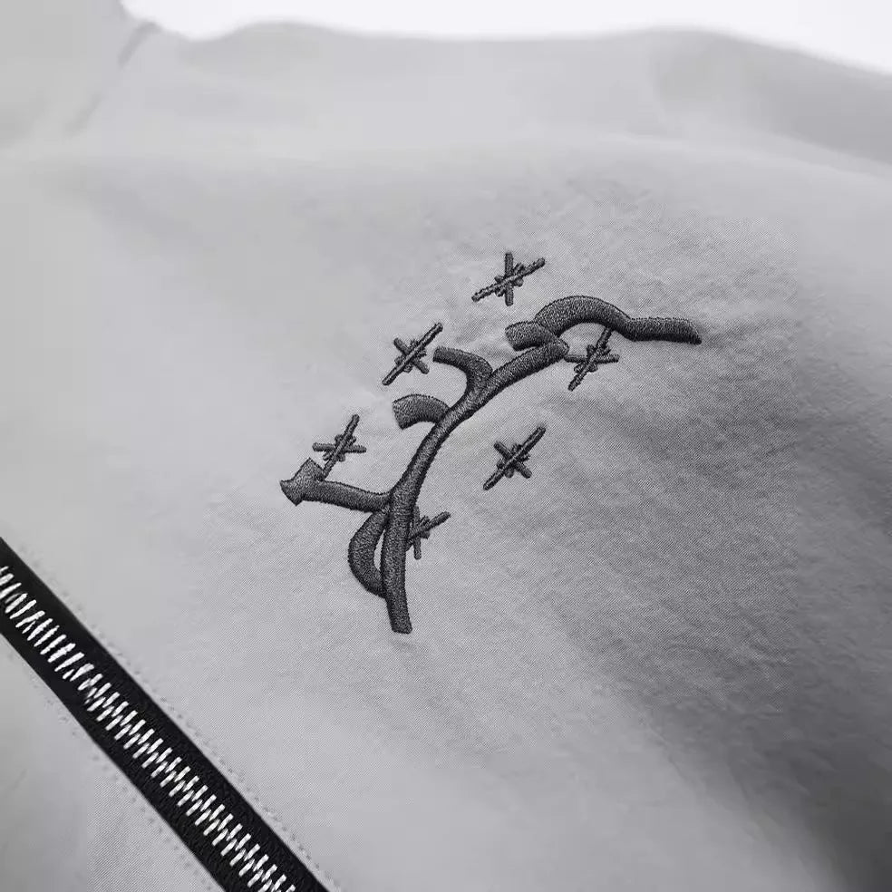 Grey loose-fit men's hooded jacket in British style on a hanger