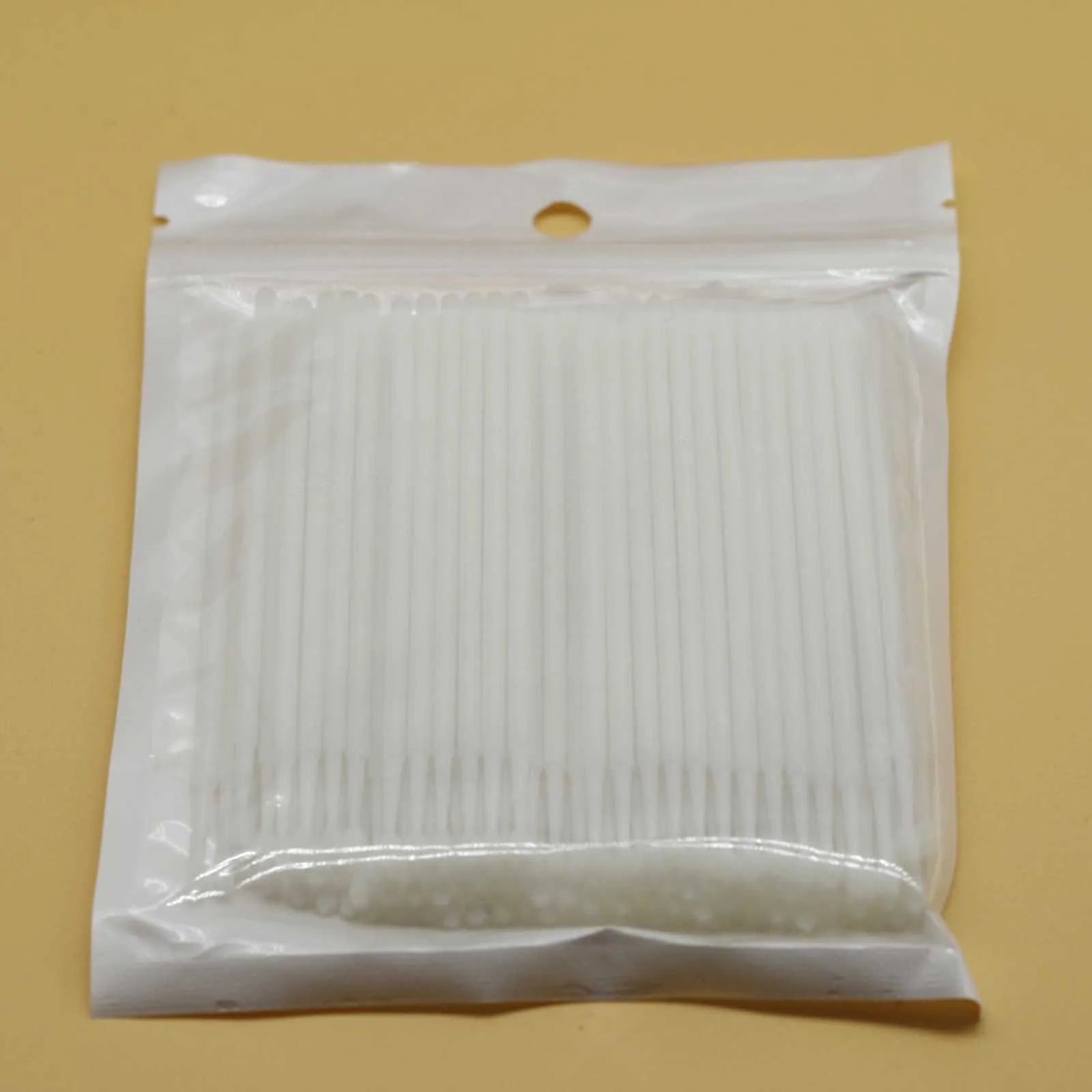 Disposable micro applicator brushes with bendable cotton tips and colour-coded handles for eyelash extensions