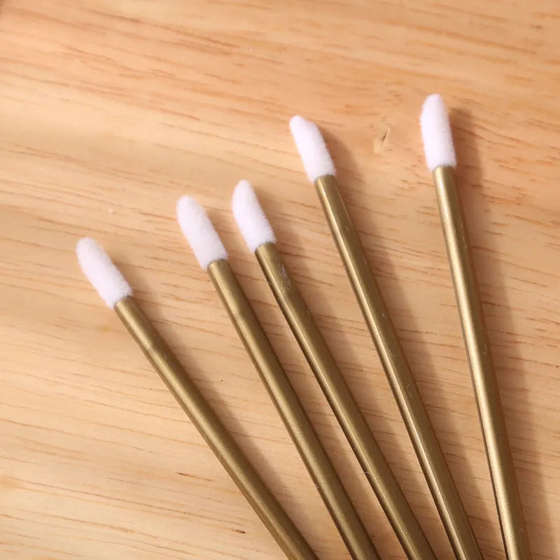 Pack of multi-colour disposable lip brush applicators with black handles and soft flocked tips.