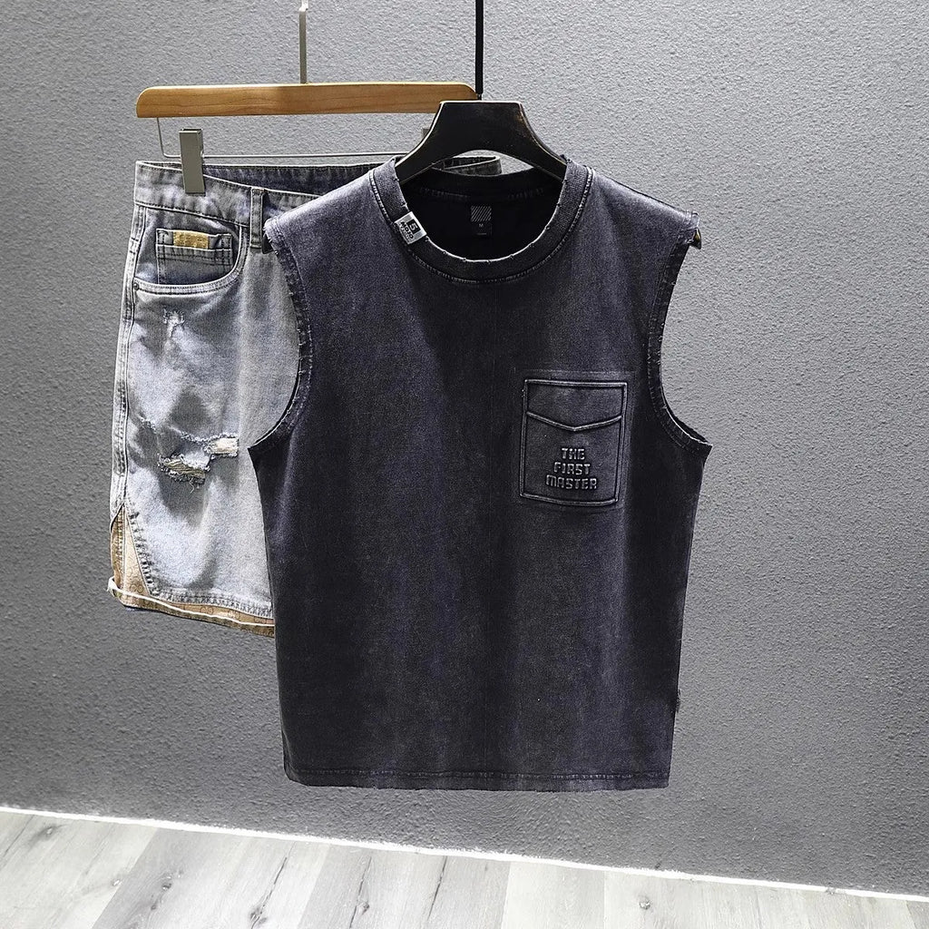 Loose fit cotton sleeveless t-shirt in black on a hanger, showing straight hem design.