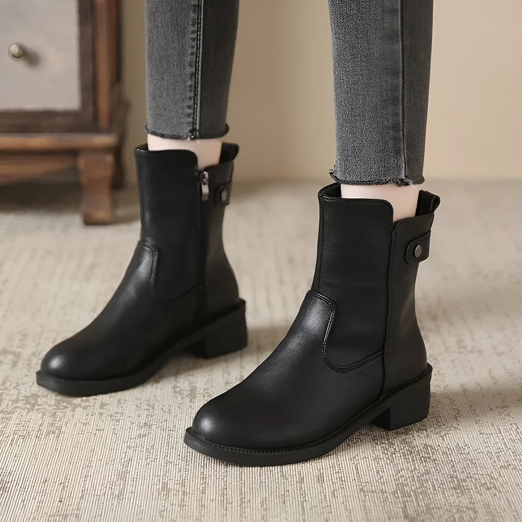 Black women's ankle boots with a side zip and round toe on a low heel.