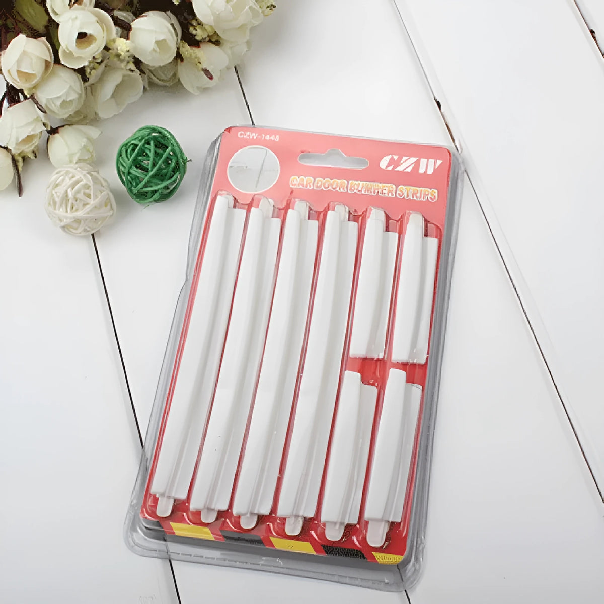 White plastic car door edge protector strip, 1 metre long with adhesive backing.