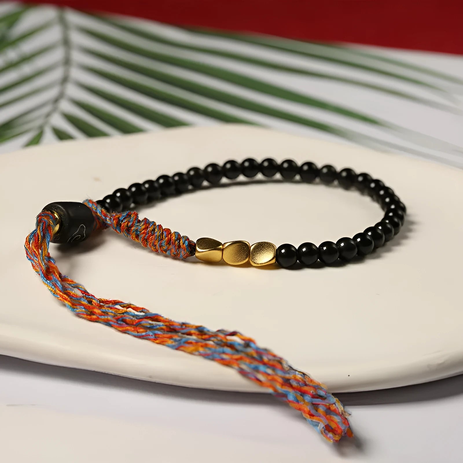 Hand-woven obsidian black wrist strap showing 4mm width and natural cord texture