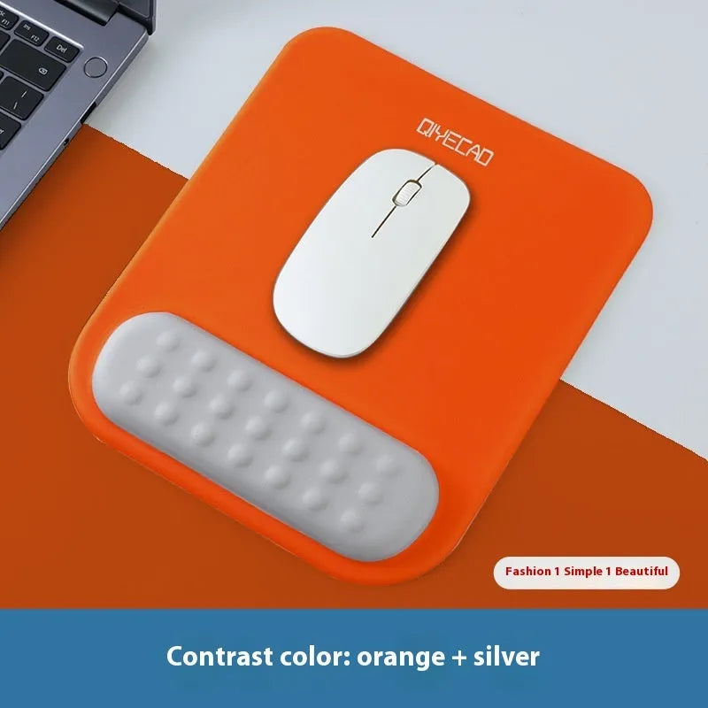 Ergonomic cloth-silicone mouse pad with raised wrist support on a desk