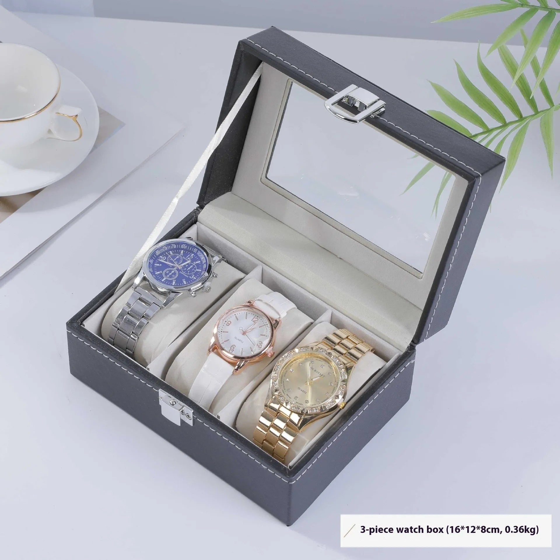 Grey leather watch storage box with transparent lid showing internal watch slots.