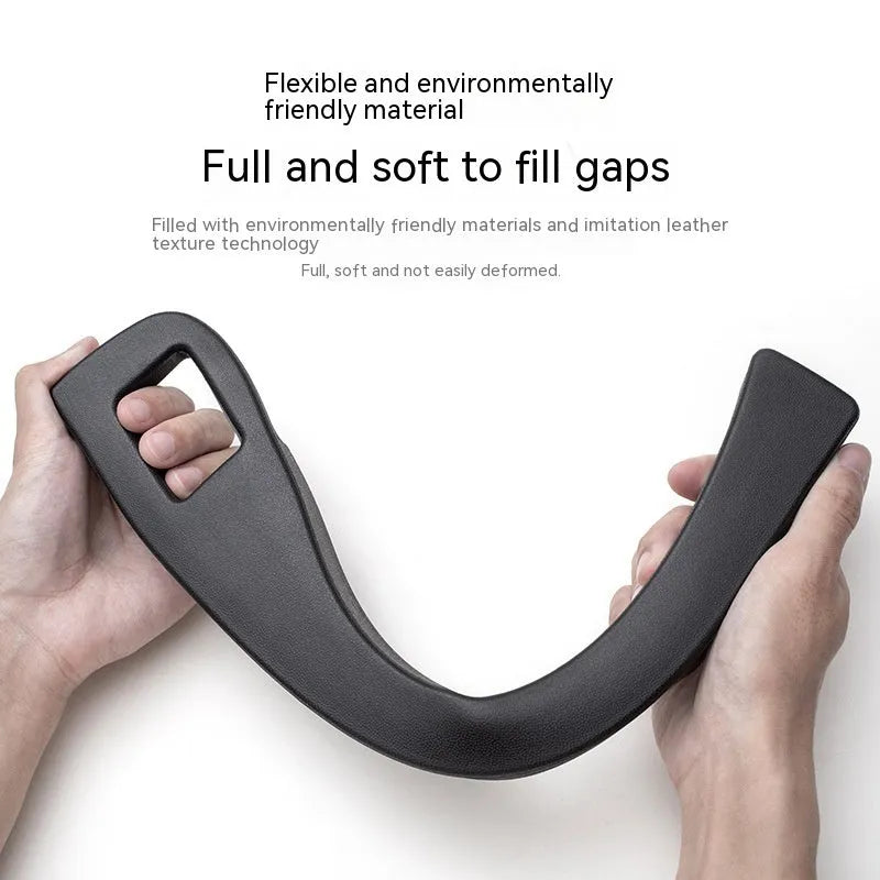 Black plastic car seat gap storage pocket with handle placed between vehicle seats.