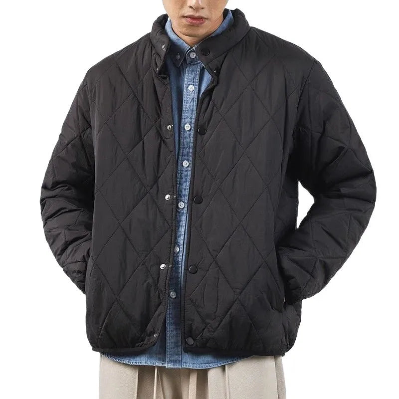 Man wearing a black diamond quilted longline winter jacket with a loose fit.