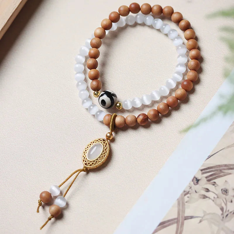 Sandalwood and opal double ring bracelet with polished finish and retro style.