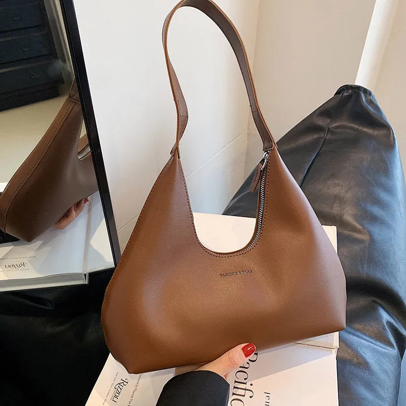 Retro style PU shoulder handbag in pillow shape with single strap and internal organisation pockets
