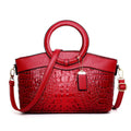 Fabric women's shoulder handbag in multiple colours showing zipper pockets and organisational compartments.