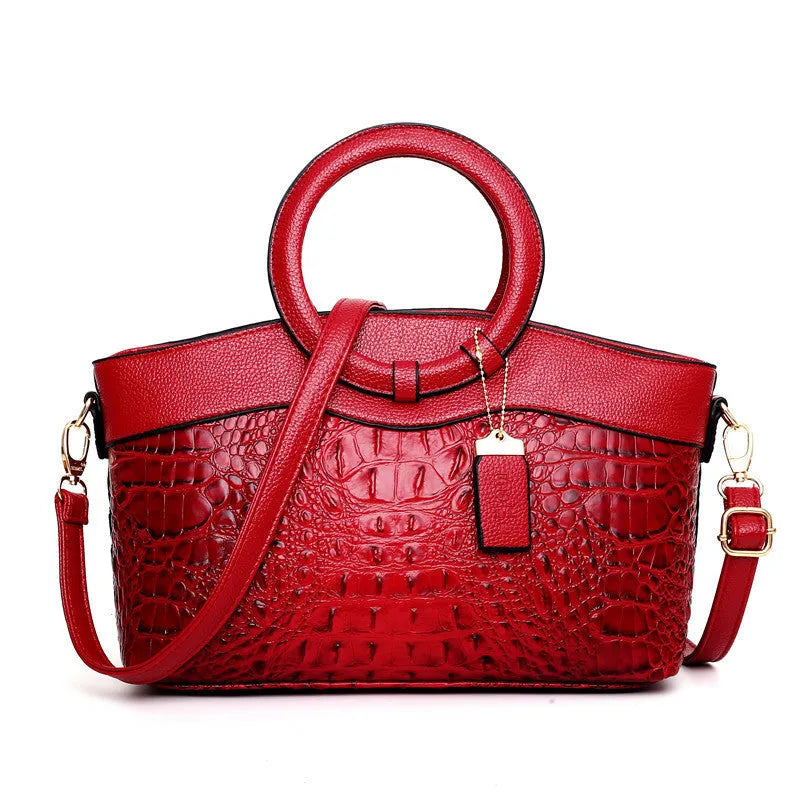 Fabric women's shoulder handbag in multiple colours showing zipper pockets and organisational compartments.