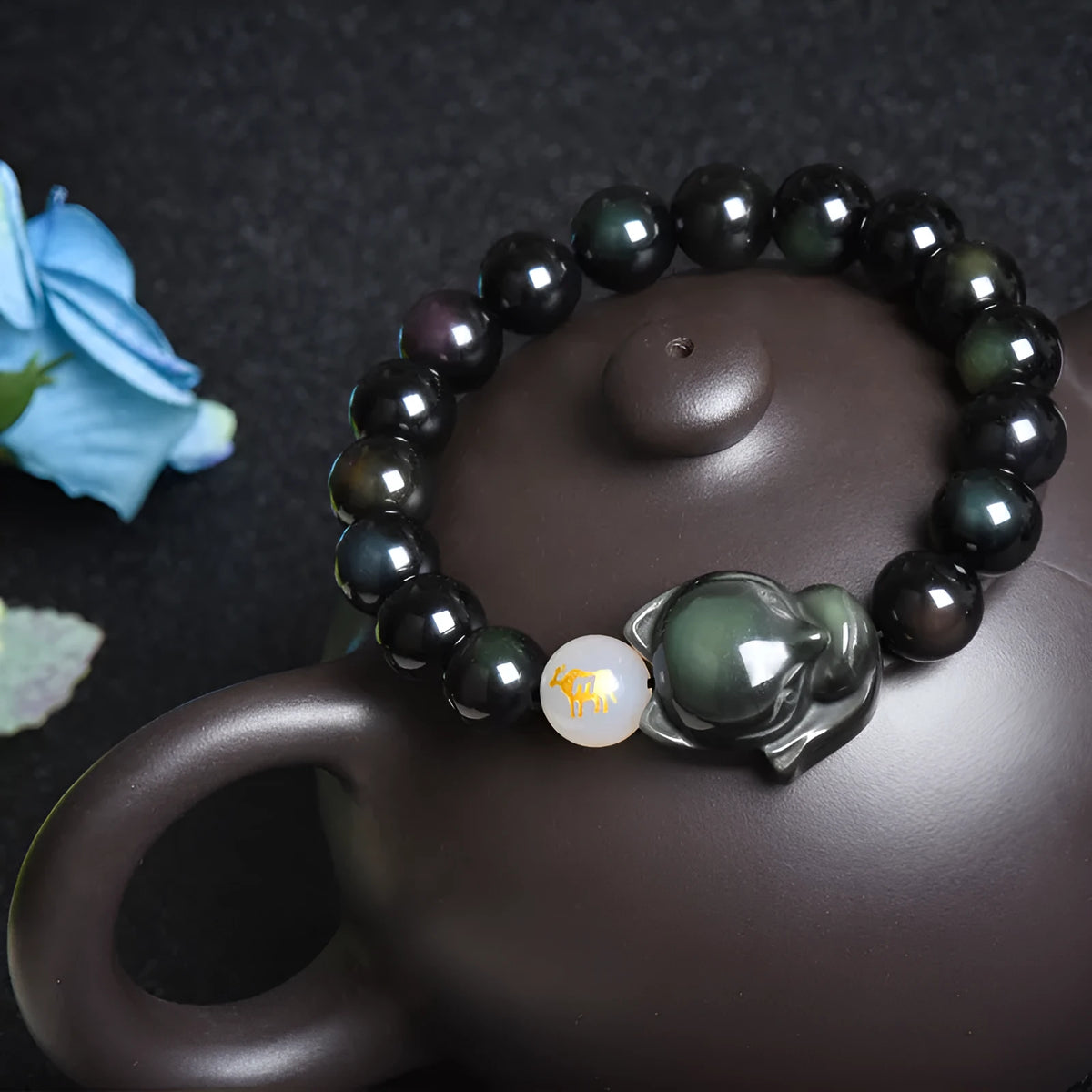 Natural obsidian bracelet with 10mm beads in gold, silver, or black finish.