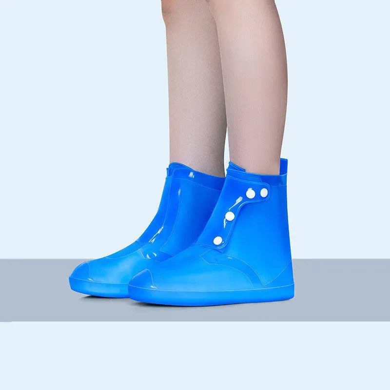 White PVC high top reusable water resistant shoe covers shown on a shoe.