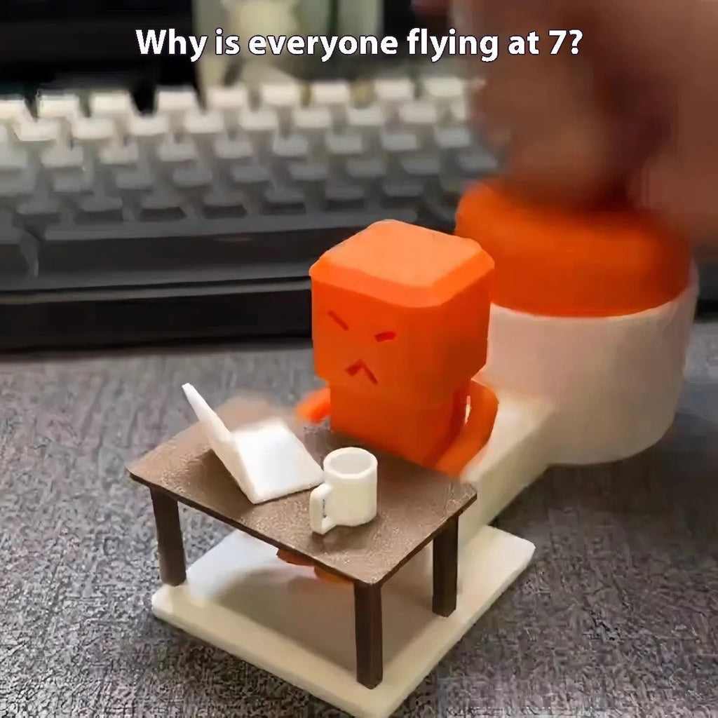 Orange plastic vent decompression toy with push buttons on a desk