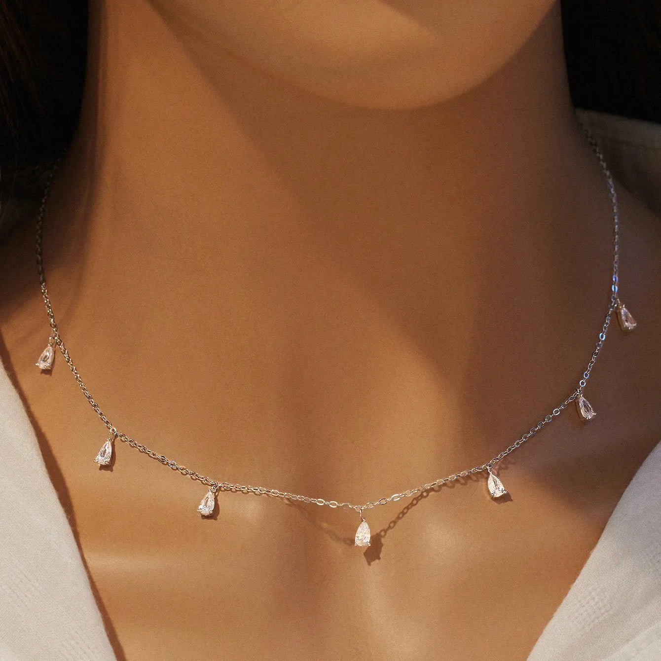 Gentle drop-shaped artificial zircon necklace on a silver O-chain, showing silver, rose gold, and golden yellow colour options.