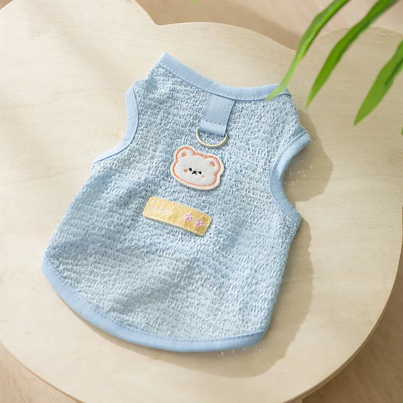 Cat wearing blue bear patch clothing with hollowed-out knitted fabric construction