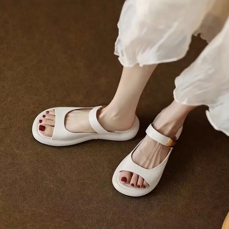 Women's apricot peep toe flat platform sandals with a soft leather upper and rubber sole.