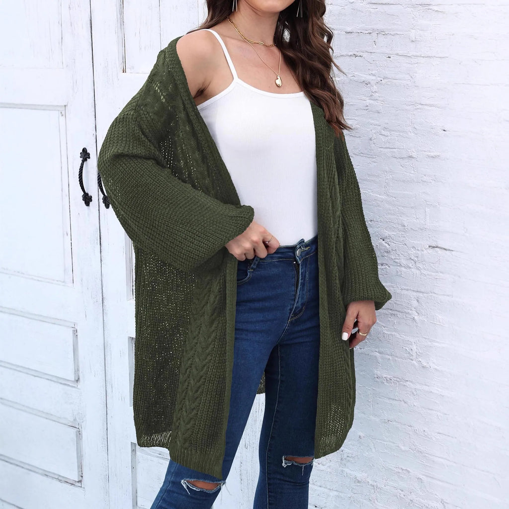 Women's loose-fitting long sleeve acrylic sweater coat in a solid colour on a hanger.