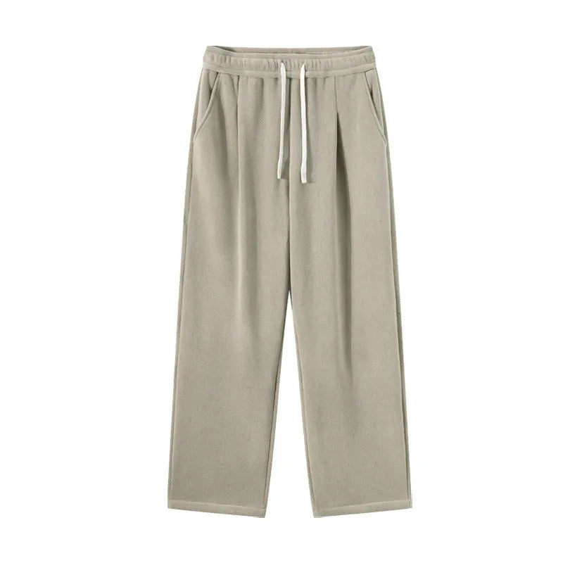 Man wearing loose apricot fleece-lined sports trousers with a drawstring waistband.