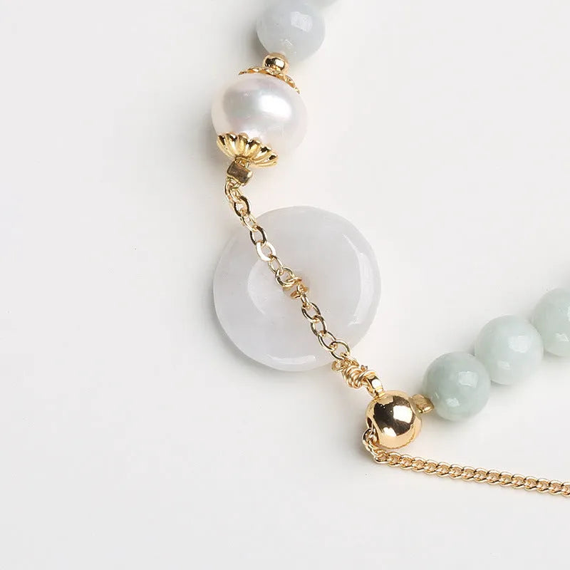Women's natural emerald peace buckle pearl bracelet with geometric jade pendant on wrist