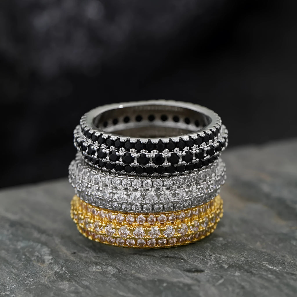 Geometric copper ring with a triangular zircon stone inlay, shown in white gold, yellow gold, and white and black plated finishes.