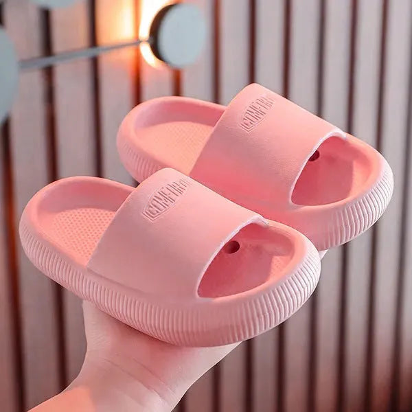 Children's bright coloured EVA slippers with textured non-slip soles, shown in blue, green, orange, pink, and yellow.