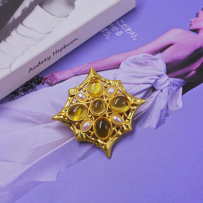 Classic vintage zinc alloy brooch with baroque-style cross design and crystal details on a dark background.